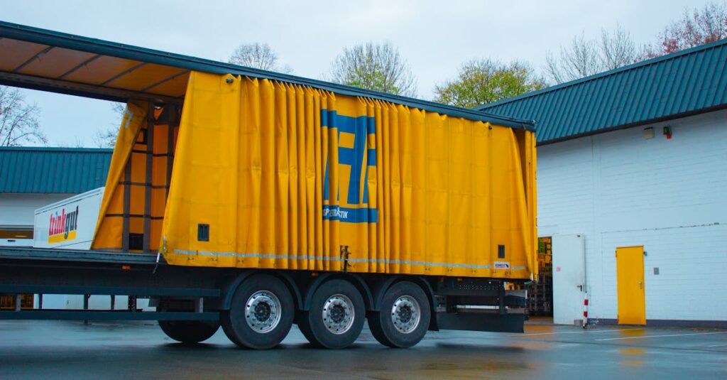 Yellow cargo truck in an industrial setting, Essen, Germany.